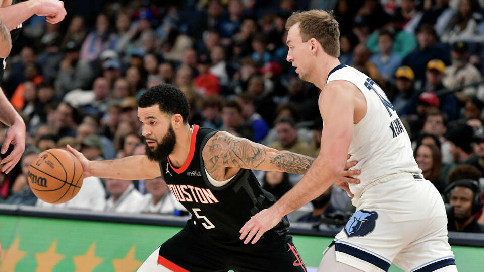 Houston Rockets guard Fred VanVleet (5) handles the ball against Memphis Grizzlies guard Luke Kennard in the first half of an NBA basketball game, Thursday, Jan. 9, 2025, in Memphis, Tenn. (AP Photo/Brandon Dill)