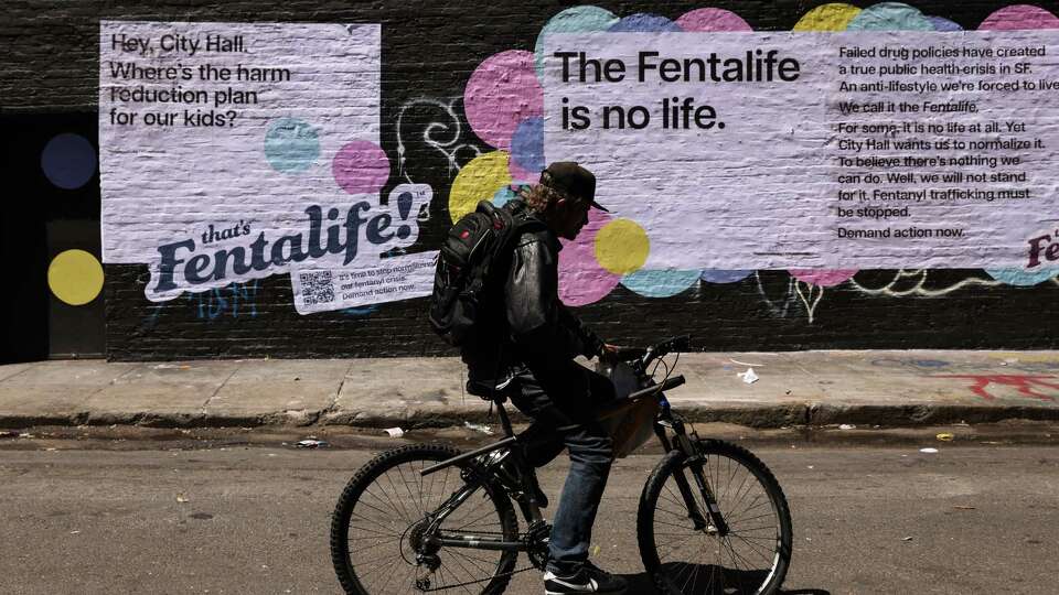 Newly posted advertisements put up by advocacy group Together SF are seen on the wall in the Tenderloin in San Francisco, Calif., Monday, May 15, 2023. The advertisements are pushing City Hall to do more to address the fentanyl crisis.