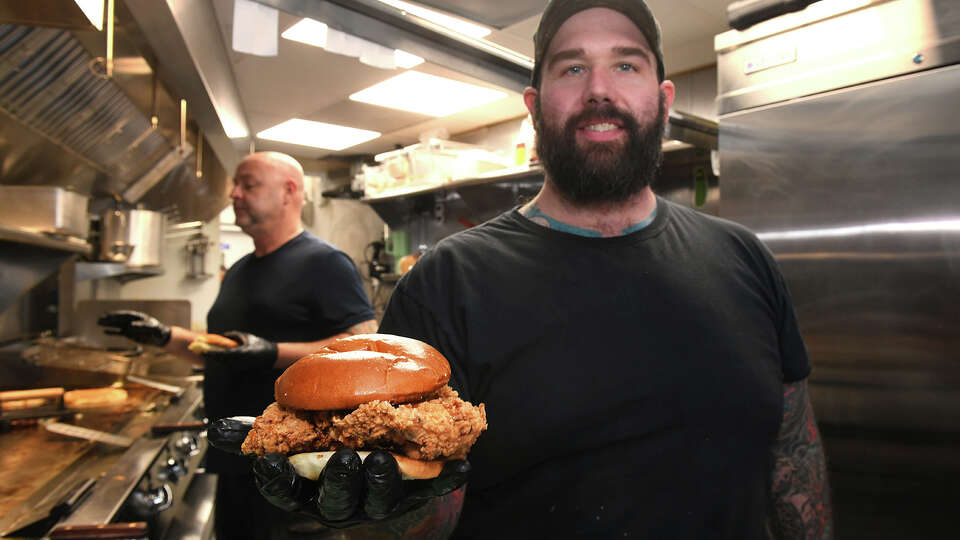 Chef Eric Felitto holds “The Hot Nashville” fried chicken sandwich at The Tasty Yolk, in Branford, Conn. Jan. 9, 2025.