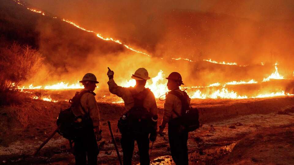 Fire crews battle the Kenneth Fire in the West Hills section of Los Angeles, Thursday, Jan. 9, 2025. (AP Photo/Ethan Swope)