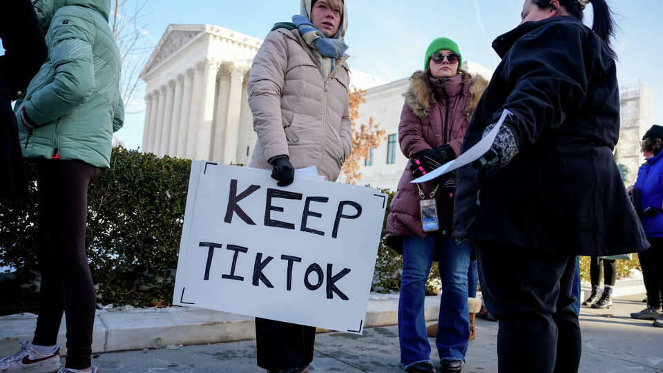 WASHINGTON, DC - JANUARY 10: (L-R) Sarah Baus of Charleston, S.C., holds a sign that reads 'Keep TikTok' as she and other content creators Sallye Miley of Jackson, Mississippi, and Callie Goodwin of Columbia, S.C., stand outside the U.S. Supreme Court Building as the court hears oral arguments on whether to overturn or delay a law that could lead to a ban of TikTok in the U.S., on January 10, 2025 in Washington, DC. The future of the popular social media platform is at stake as the Supreme Court hears arguments on a law set to take effect the day before Inauguration Day that would force their China-based parent company to cut ties with TikTok due to national security concerns. (Photo by Andrew Harnik/Getty Images)