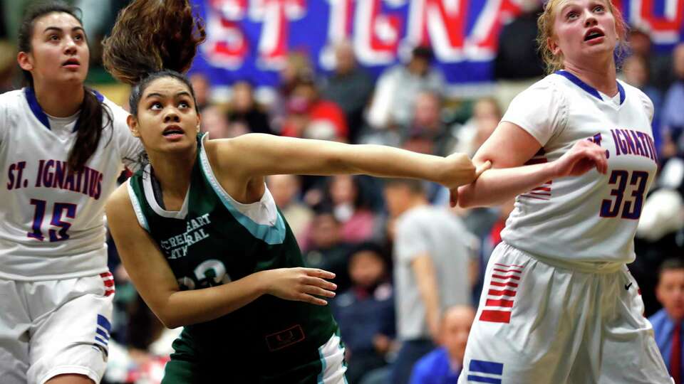 St. Ignatius' Madeline Ennis (right) and Sacred Heart Cathedral's Taloauau Li-Uperesa vie for rebound position in 2nd quarter during Bruce Mahoney girls' basketball game at USF War Memorial Gymnasium in San Francisco, Calif., on Monday, January 9, 2018.