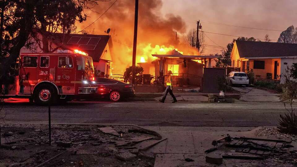 Flames from the Eaton fire consume a home in Altadena on Wednesday, Jan. 8, 2025.