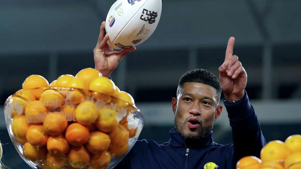 MIAMI GARDENS, FLORIDA - JANUARY 09: Head coach Marcus Freeman of the Notre Dame Fighting Irish raises a game ball after defeating the Penn State Nittany Lions 27-24 in the Capital One Orange Bowl at Hard Rock Stadium on January 09, 2025 in Miami Gardens, Florida.