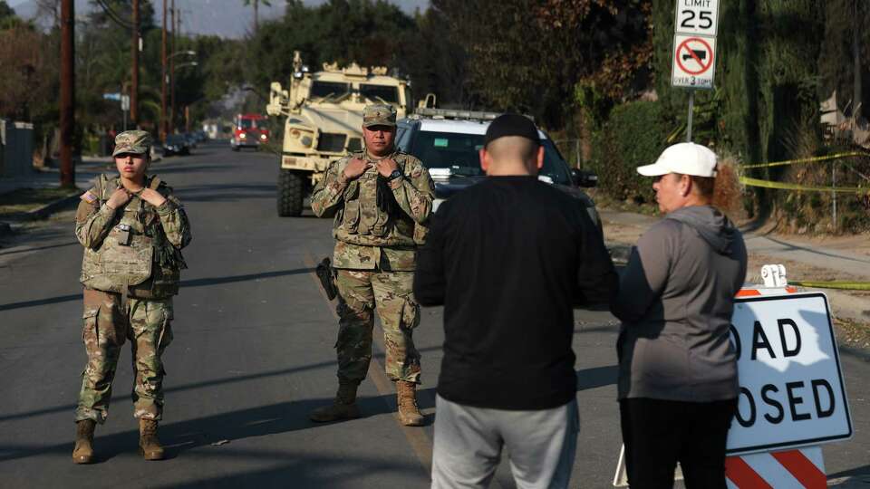 ALTADENA, CALIFORNIA - JANUARY 10: Members of the National Guard man a checkpoint for the Eaton Fire on January 10, 2025 in Altadena, California. Fueled by intense Santa Ana Winds, the Eaton Fire has grown to over 13,000 acres and has destroyed over 5,000 homes and businesses. Five people have lost their lives in the fire.