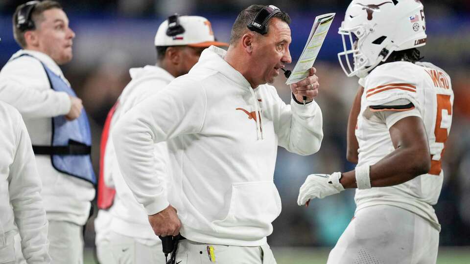 Texas head coach Steve Sarkisian makes a call from the bench during the second half of a College Football Playoff semifinal game at the Goodyear Cotton Bowl, Friday, Jan. 10, 2025, in Arlington.