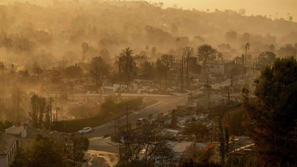 The devastation of the Palisades Fire is seen in the early morning in the Pacific Palisades neighborhood of Los Angeles, Friday, Jan. 10, 2025. (AP Photo/John Locher)