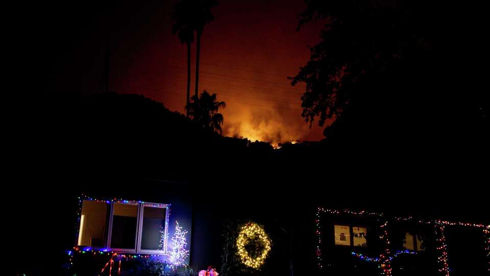 The Palisades Fire burns on a hilltop near the Mandeville Canyon neighborhood of Los Angeles,, Calif., Friday, Jan. 10, 2025.