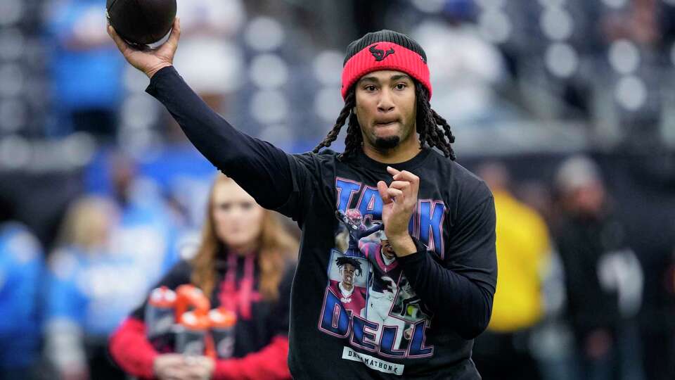 Houston Texans quarterback C.J. Stroud wears a t-shirt honoring injured teammate Tank Dell while warming up before an AFC Wild Card playoff football game against the Los Angeles Chargers, Saturday, Jan. 11, 2025, in Houston. Dell injured his knee on Dec. 21 making a touchdown catch against the Kansas City Chiefs.