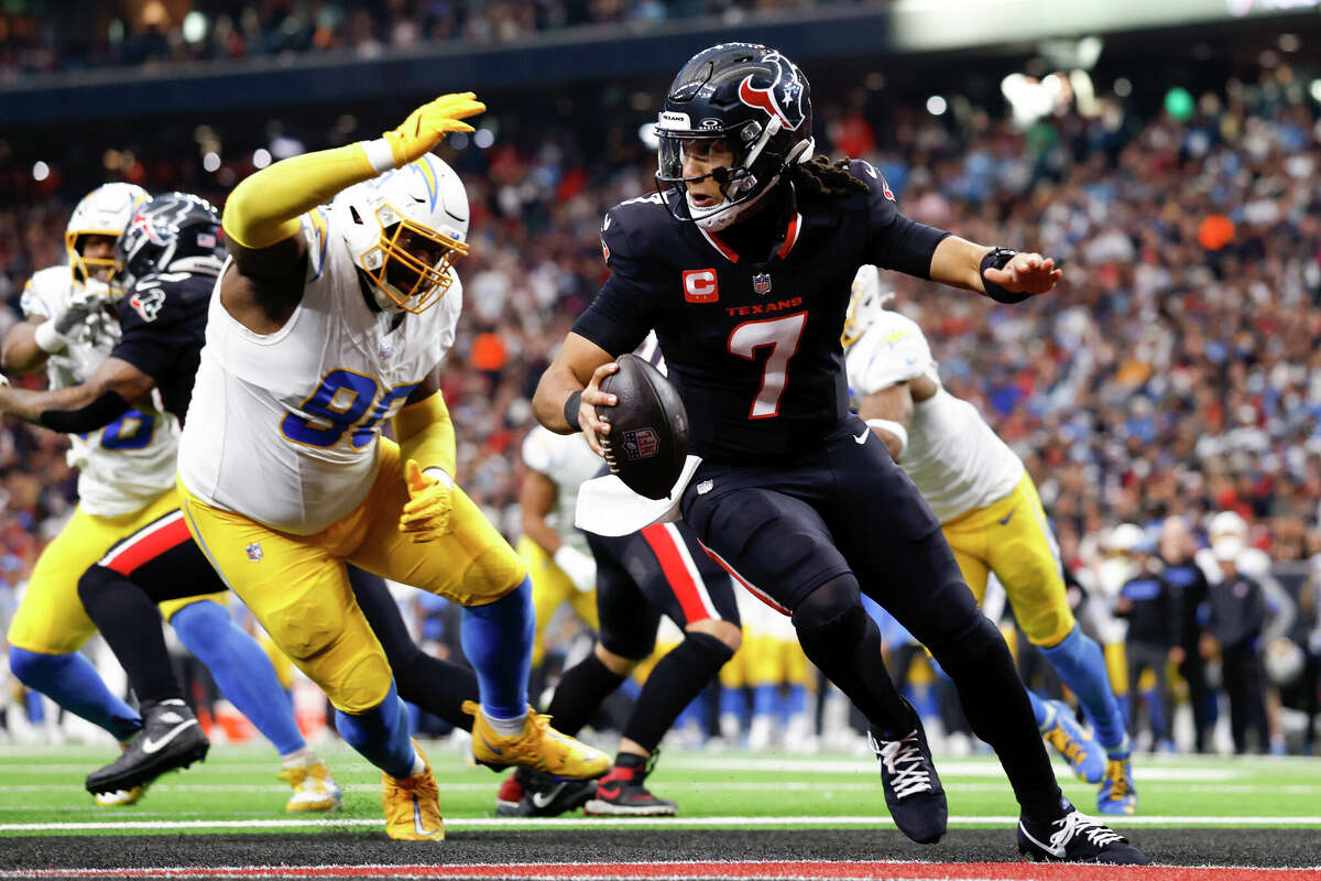 Teair Tart #90 of the Los Angeles Chargers pressures C.J. Stroud #7 of the Houston Texans in the second quarter during the AFC Wild Card Playoffs at NRG Stadium on January 11, 2025 in Houston, Texas.