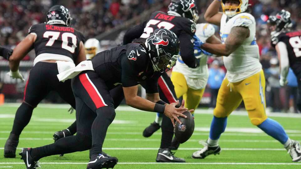 Houston Texans quarterback C.J. Stroud (7) recovers a fumble during the first half of an AFC Wild Card playoff football game, Saturday, Jan. 11, 2025, in Houston.