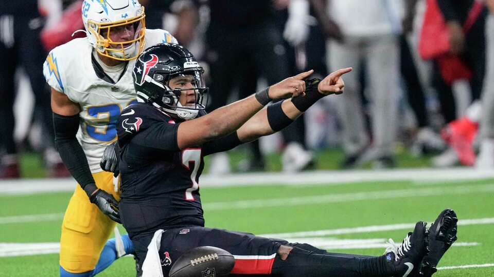 Houston Texans quarterback C.J. Stroud (7) points forward after being brought down by Los Angeles Chargers safety Alohi Gilman (32) after running for nine yards during the second half of an AFC Wild Card football game, Saturday, Jan. 11, 2025, in Houston.