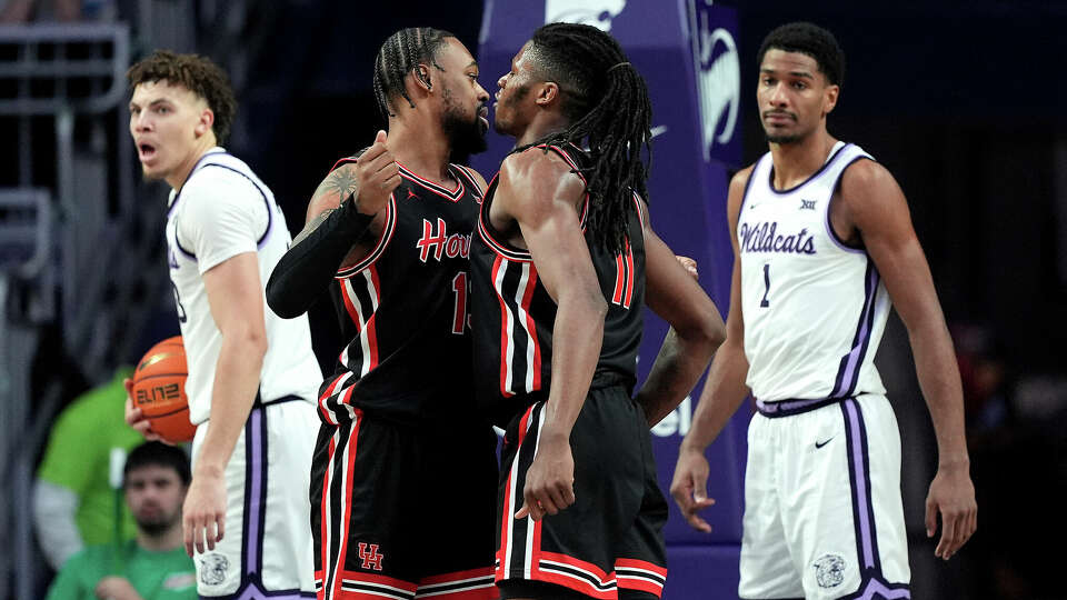 Houston forward Joseph Tugler (11) and Houston forward J'Wan Roberts, center left, celebrate during the second half of an NCAA college basketball game against Kansas State, Saturday, Jan. 11, 2025, in Manhattan, Kan. (AP Photo/Charlie Riedel)