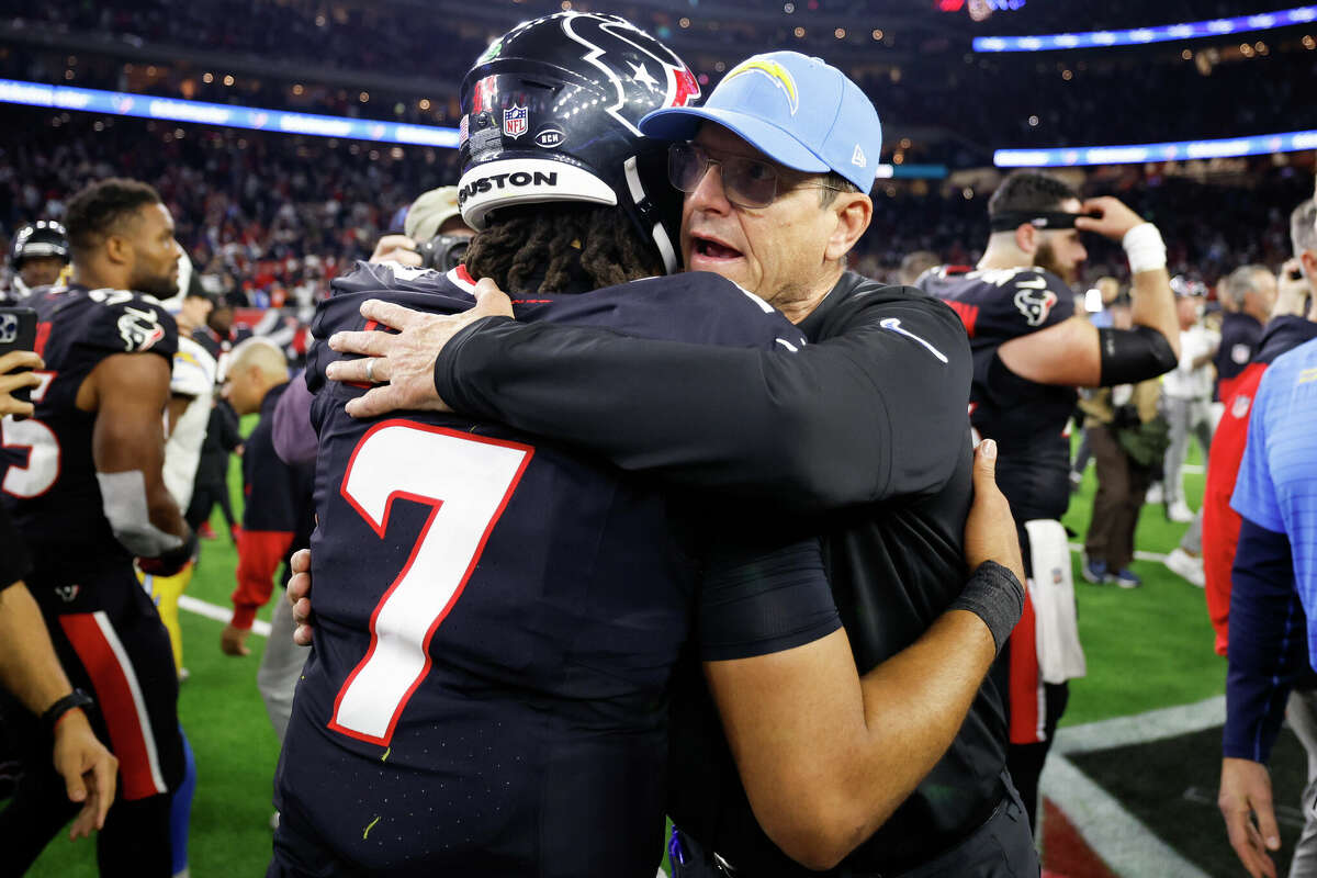 C.J. Stroud #7 of the Houston Texans and head coach Jim Harbaugh of the Los Angeles Chargers embrace on the field after their game during the AFC Wild Card Playoffs at NRG Stadium on January 11, 2025 in Houston, Texas. 