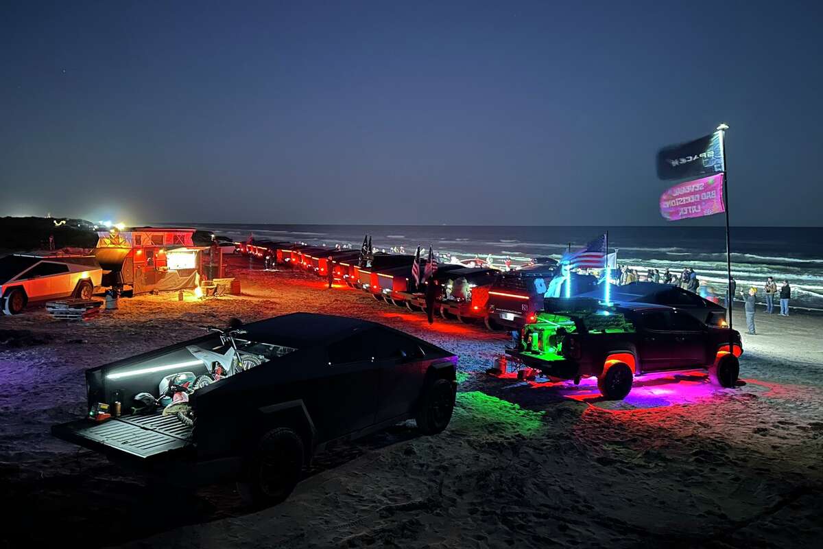Tesla Cybertrucks lined up along Boca Chica Beach for a light show Saturday. 