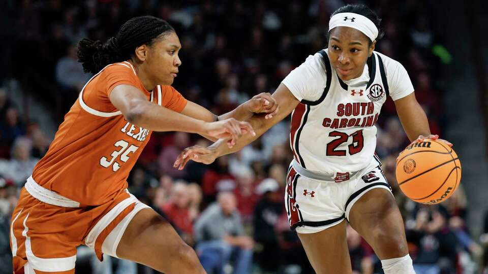 South Carolina guard Bree Hall (23) drives against Texas forward Madison Booker during the first half of an NCAA college basketball game in Columbia, S.C., Sunday, Jan. 12, 2025.