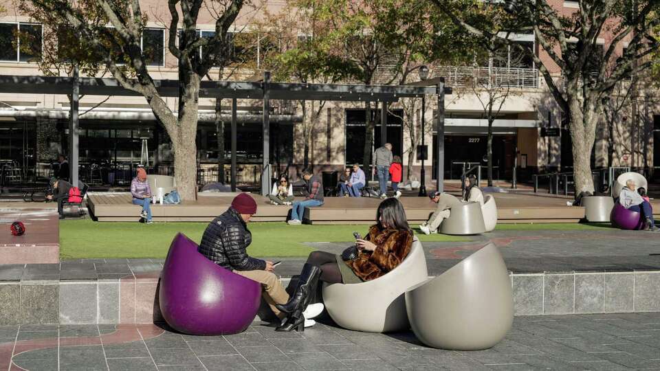 People relax in the sun at Sugar Land Town Square on Saturday, Jan. 11, 2025 in Sugar Land.
