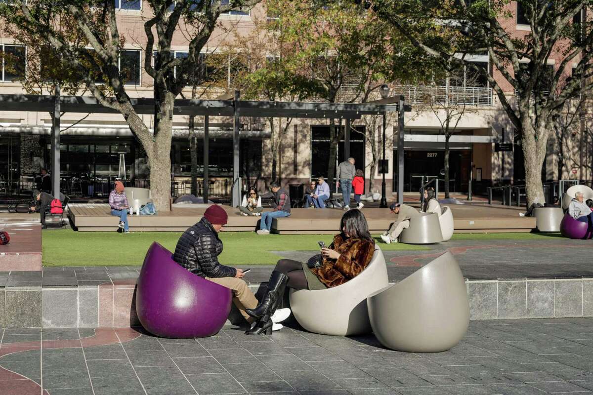 People relax in the sun at Sugar Land Town Square on Saturday, Jan. 11, 2025 in Sugar Land.