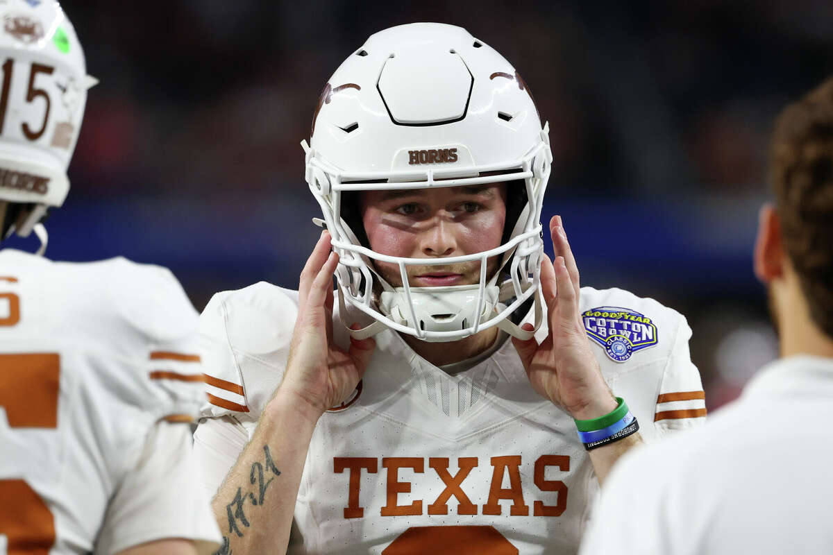 ARLINGTON, TX - JANUARY 10: Quarterback Quinn Ewers #3 of the Texas Longhorns reaches for his helmet during warmups before the Ohio State Buckeyes versus Texas Longhorns College Football Playoff Semifinal at the Cotton Bowl Classic on January 10, 2025, at AT&T Stadium in Arlington, TX. (Photo by David Buono/Icon Sportswire via Getty Images)