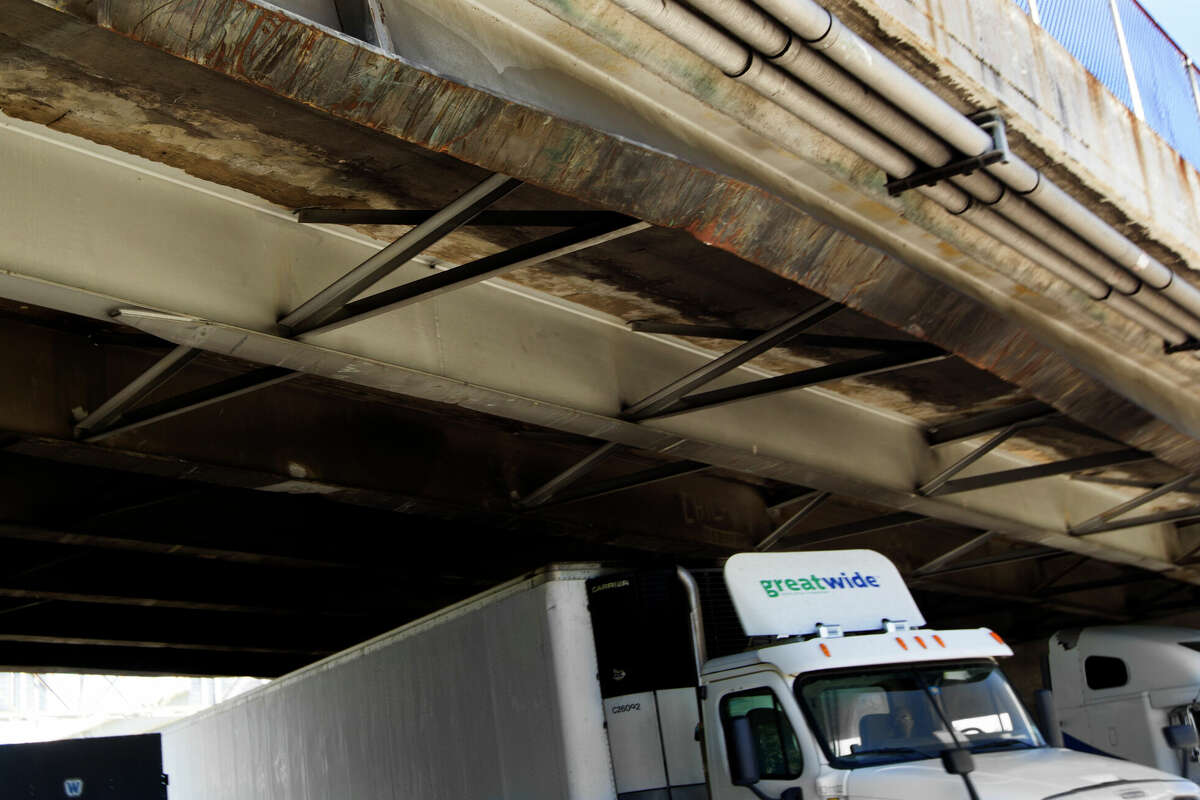 A beam on the Houston Ave. bridge over I-10 is bent after an eighteen wheel truck with oil field reel tubing as cargo hit it around 11:45 a.m. on Tuesday, Oct. 14, 2014, in Houston. (J. Patric Schneider / For the Chronicle )