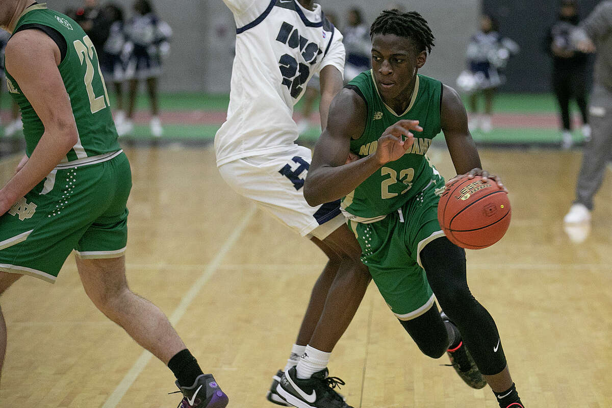 Notre Dame's #23 Abdou Toure steps around Hillhouse #22 Avery Sutton during a CIAC high school boys basketball game at Floyd Little Athletic Center in New Haven, Conn., Monday, January 13, 2025.