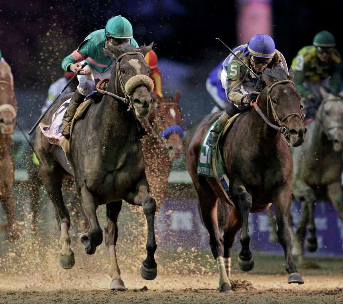 Garrett Gomez, right, rides Blame to victory during the Classic race at the Breeder's Cup horse races at Churchill Downs Saturday, Nov. 6, 2010, in Louisville, Ky. Mike Smith riding Zenyatta finished second. (AP Photo/Darron Cummings)
