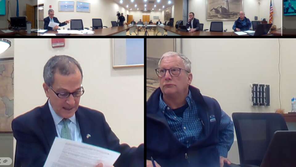 Old Saybrook First Selectman Carl Fortuna (lower left) reads from a document during a meeting Tuesday morning which included a discussion of a report citing Police Chief Michael Spera with several missteps. 