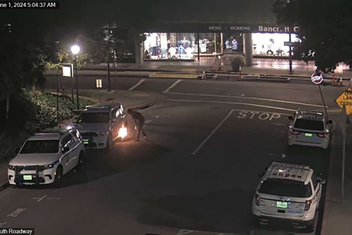 Surveillance footage from June 1, 2024, shows a figure watching a fire begin to burn underneath a University of California Police Department car.