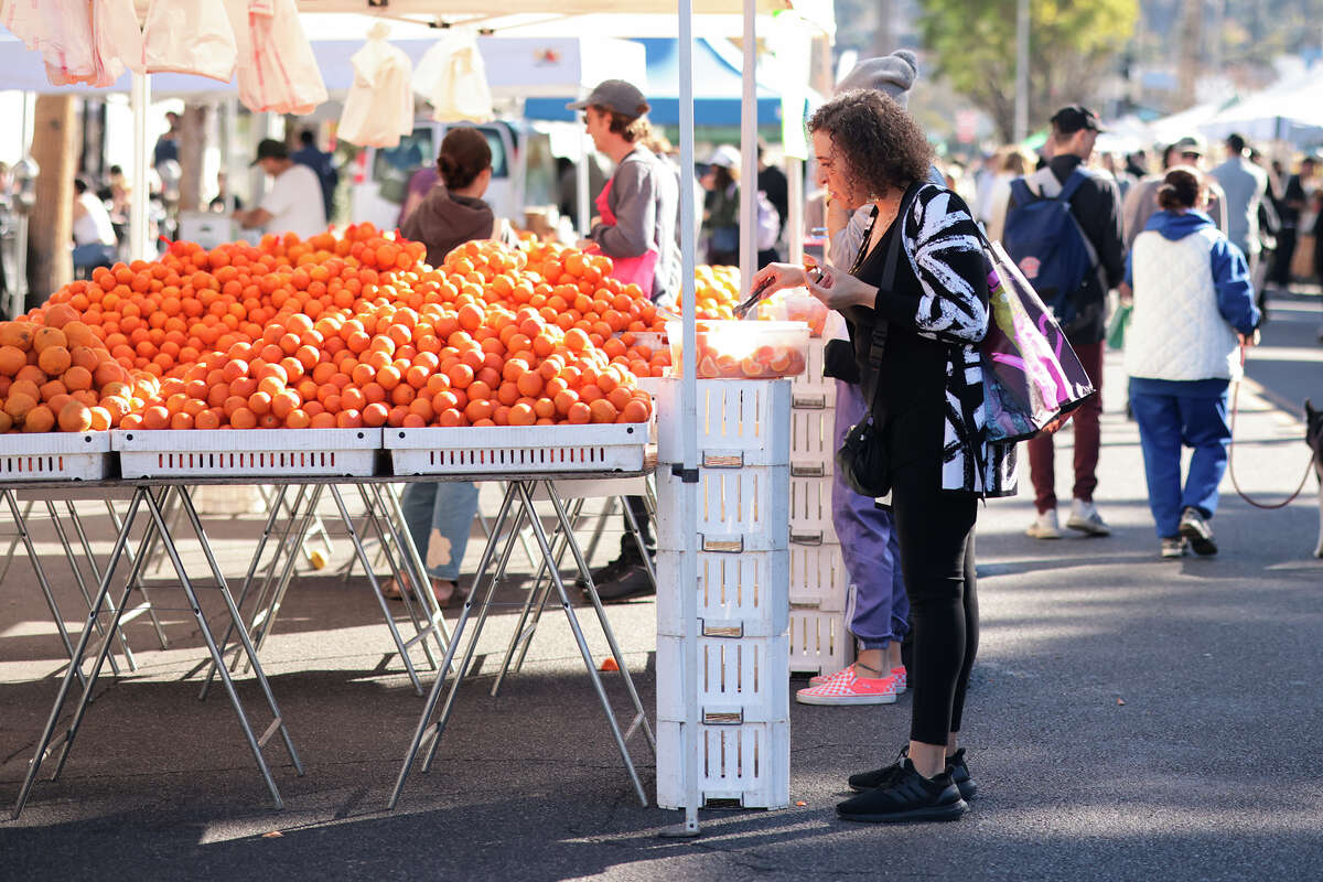 A customer looks at produce at the Studio City Farmers Market on January 12, 2025 in Los Angeles, Calif.