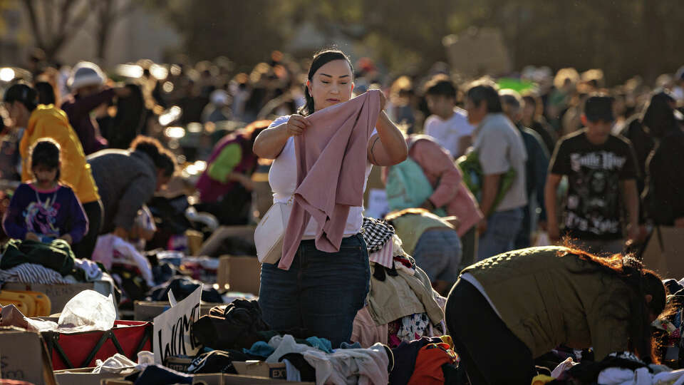 Community members stop by a donation center that has taken over the parking lot at the Santa Anita Racetrack to gather much needed food, water, clothes and supplies after the Eton fire in Altadena on Monday, Jan. 13, 2025 in Arcadia, CA. 