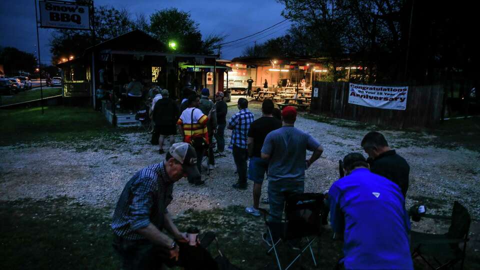 A line of customers waits for Snow's BBQ to open its doors at 8 a.m. Saturday, March 24, 2018 in Lexington. The first customers arrived at the barbecue joint before 6 a.m.