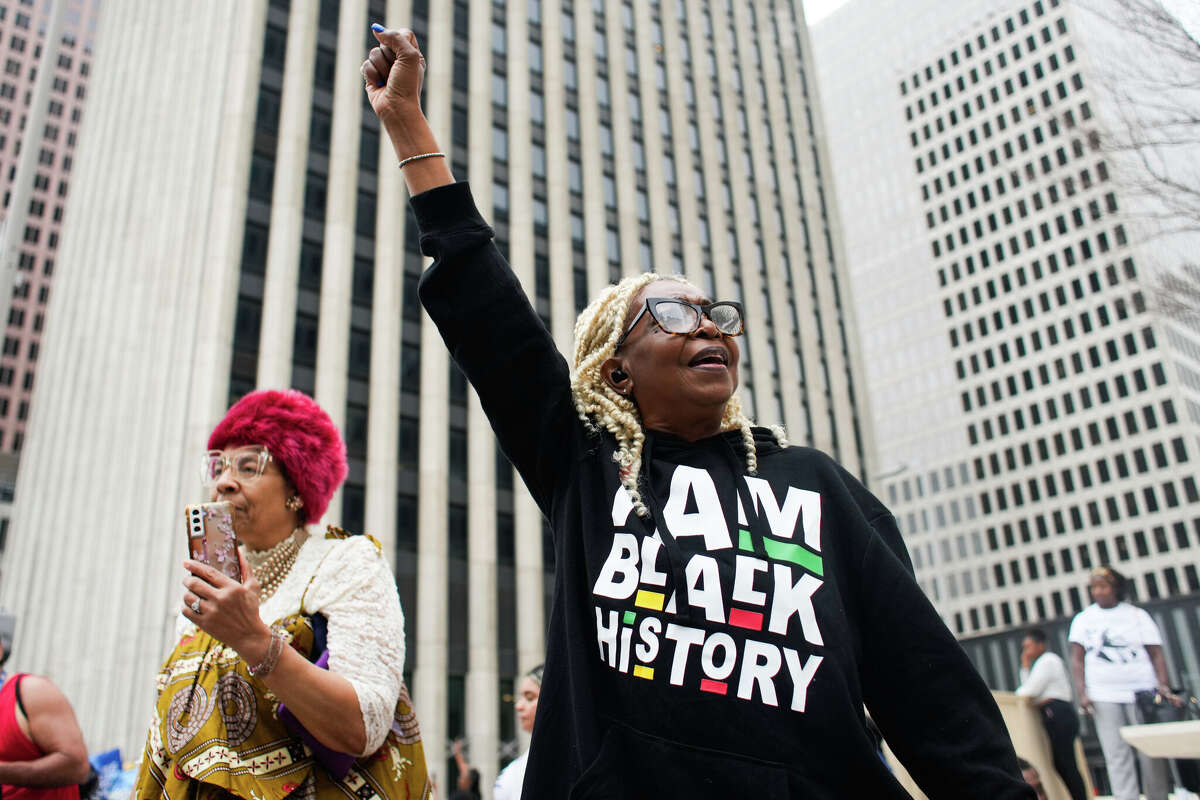 Debra Banies raises her fist during the annual MLK Parade through downtown Houston, Saturday, Feb. 10, 2024. The city of Houston and the Black Heritage Society Inc. partner together to present the reschedule event that was moved form its original date on MLK Day due to freezing weather