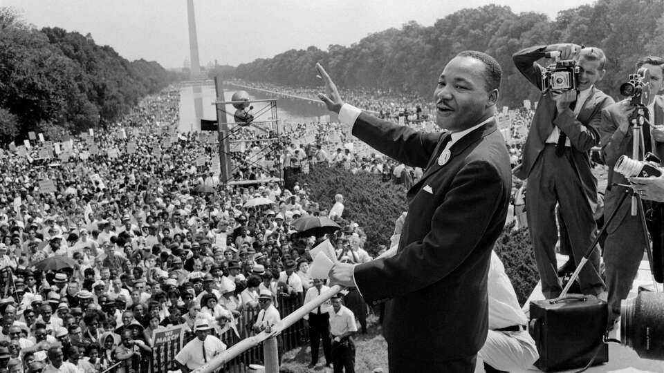 US civil rights leader Martin Luther King (C) waves to supporters 28 August 1963 on the Mall in Washington DC (Washington Monument in background) during the 'March on Washington', where King delivered his famous 'I Have a Dream' speech, which mobilized supporters of desegregation and prompted the Civil Rights Act of 1964. King said the march was 'the greatest demonstration of freedom in the history of the United States.' Martin Luther King was assassinated on 04 April 1968 in Memphis, Tennessee. James Earl Ray confessed to shooting King and was sentenced to 99 years in prison. King's killing sent shock waves through American society at the time, and is still regarded as a landmark event in recent US history. 