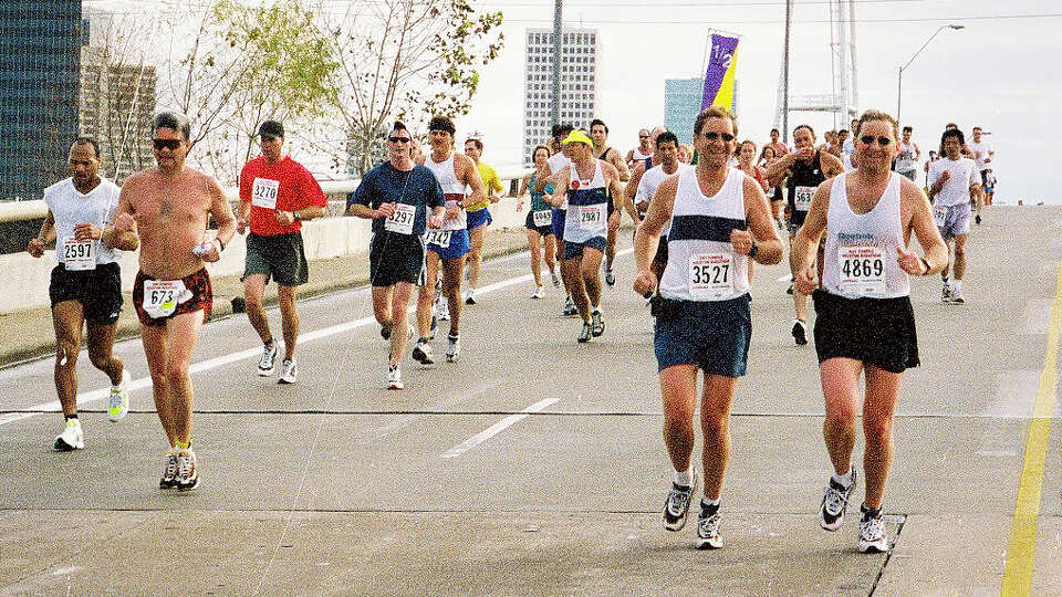 Twin brothers Ken and Jeff Herd running in the 2001 Houston Marathon. The brothers have run a combined 41 marathons and half marathons in Houston.