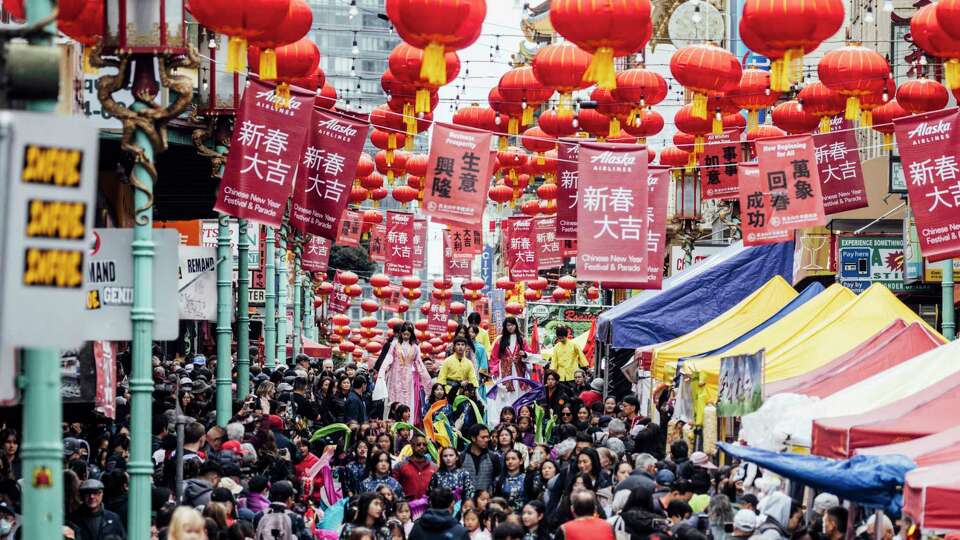 Performers on stilts walk during a parade procession to kick off the annual Lunar New Year Celebrations in San Francisco Chinatown, Saturday, Feb. 3, 2024.