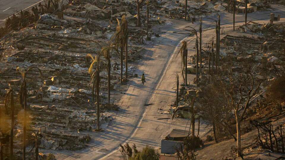 Homes destroyed by the Palisades Fire are seen during sunset in Pacific Palisades, Calif., Friday, Jan. 10, 2025.