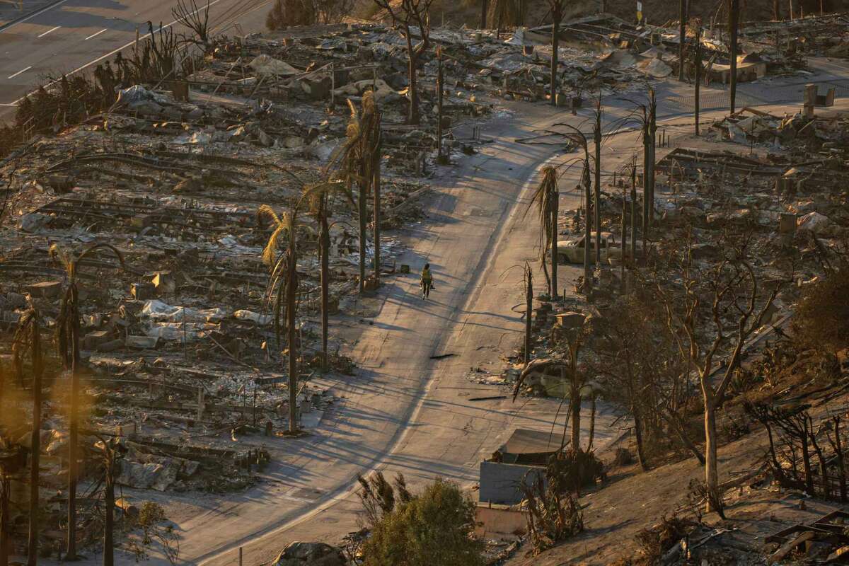 Destroyed homes are seen in Pacific Palisades on Friday. State Farm is the largest insurer in California and has significant exposure in the fire area.