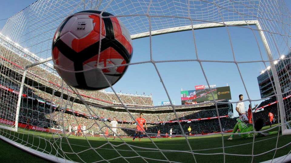 In this Saturday, June 18, 2016 photo, Mexico goalkeeper Guillermo Ochoa, bottom right, is beaten for a goal on a shot from Chile's Edson Puch during the first half of a Copa America Centenario quarterfinal soccer match at Levi's Stadium in Santa Clara, Calif. The defending champions thoroughly dismantled Mexico from every angle in the 7-0 defeat.