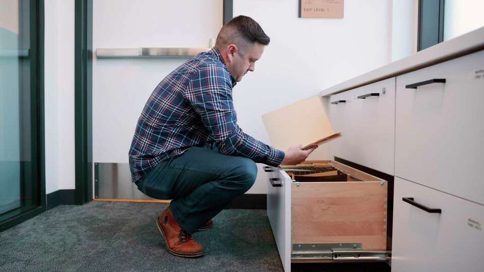 Detective Matthew Hutchison goes through storage units of cold-case files at the Department of Public Safety in Sunnyvale, Calif., Tuesday, Sept. 05, 2023.