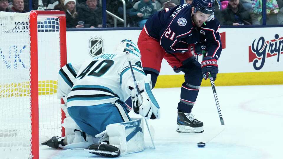 Columbus Blue Jackets left wing James van Riemsdyk (21) shoots on San Jose Sharks goaltender Alexandar Georgiev (40) in the second period of an NHL hockey game Thursday, Jan. 16, 2025, in Columbus, Ohio.