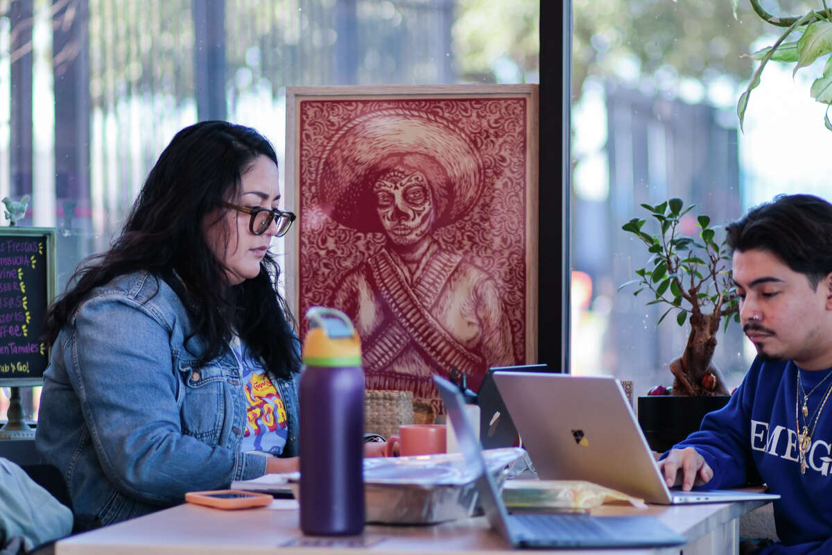 Cochinita owner Victoria Elizondo works in a restaurant's corner with Jorge Valenzuela.