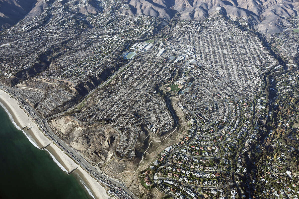 An aerial view of homes destroyed in the Palisades Fire as wildfires cause damage and loss through the LA region on January 13, 2025 in Pacific Palisades, California.