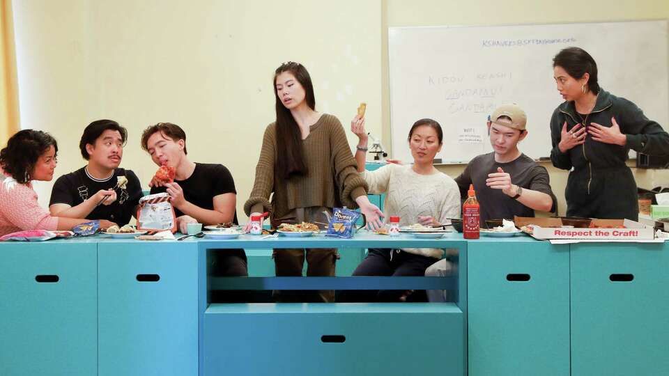 Jesca Prudencio, left tor right, director; and actors Phil Wong, James Aaron Oh, Ana Ming Bostwick-Singer, Nicole Tung, Edric Young, and Francesca Fernandez recreate the last supper with a table laden with snacks containing msg after running scenes for San Francisco Playhouse's Northern California premiere of Exotic Deadly: Or the MSG Play on Friday, January 17, 2025 in San Francisco, Calif. A bag of shrimp chips sits on a table among other snacks containing msg as cast enjoy a snack after running scenes for San Francisco Playhouse's Northern California premiere of Exotic Deadly: Or the MSG Play on Friday, January 17, 2025 in San Francisco, Calif. Exotic Deadly: Or the MSG Play runs Jan. 30-March 8.