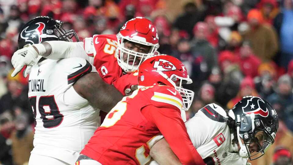 Houston Texans quarterback C.J. Stroud (7) is sacked by Kansas City Chiefs defensive end George Karlaftis (56) during the second half of an AFC Divisional playoff football game, Saturday, Jan. 18, 2025, in Kansas City, Mo.