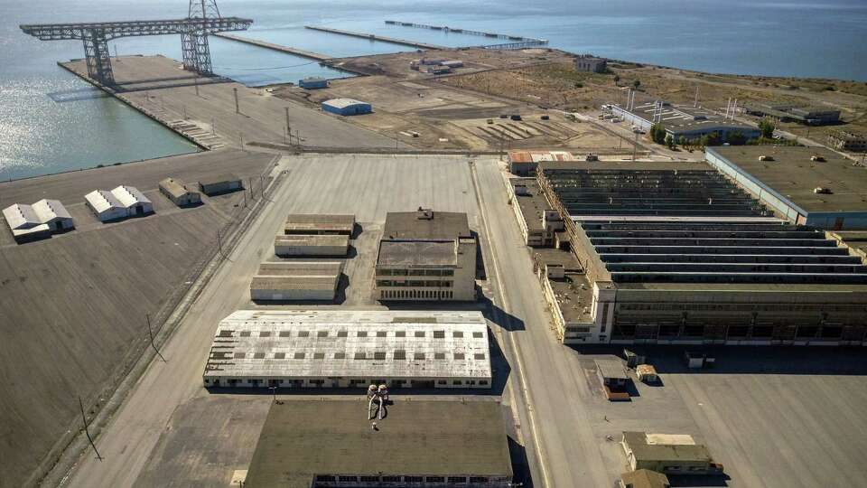 Aerial photos of Hunters Point Naval Shipyard showing Buildings 366 (white on left, middle) 351, above that on the right, and 411 (middle on the right) in Parcel G in San Francisco, Calif., on Tuesday, September 11, 2018. The Navy's retesting plan for Parcel G is being brought into question. When the U.S. Navy pledged to perform new soil tests at its Superfund waste site in San Francisco, the priority was 'to protect the human health and the environment.' But the Navy's re-testing plan is largely based on a cost-cutting report it paid a defense contractor to put together more than six years ago. What's more, the old report relies on data collected by Tetra Tech, the cleanup firm that submitted fake measurements and got caught. It essentially advocates for lowering cleanup standards and leaving more radioactivity in the ground. Multiple government agencies have now come out against the Navy?s plan to re-test Parcel G, saying that it could put public health at risk if it is not changed. Environmental experts agree and say even if the Navy listens to those agencies the plan is flawed and falls far short of what was promised in the wake of the Tetra Tech fraud revelations.