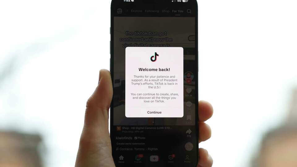 WASHINGTON D.C. - JANUARY 19: In this photo illustration an iPhone displays a popup message on the social media platform TikTok on January 19, 2025 in Washington, D.C. The popular platform is now welcoming users back after being unavailable on January 18 to users inside of the United States after a U.S. Supreme Court ban took effect.