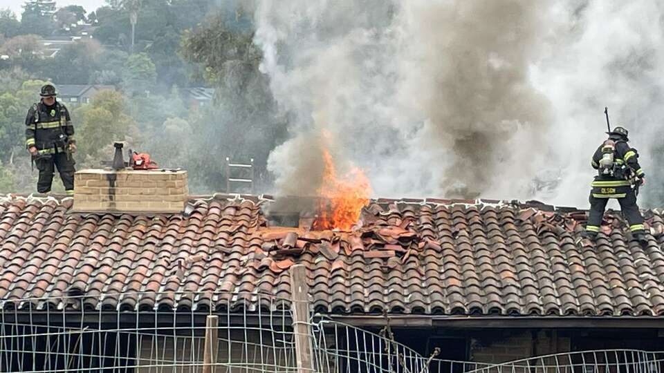 Cal Fire firefighters pulled two people and an animal from a house fire in Emerald Lake Hills in unincorporated San Mateo County.