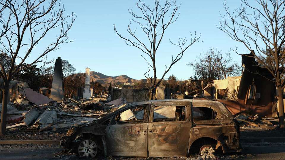 A burned out min-van during aftermath of Palisades Fire in Pacific Palisades, California on Sunday, January 12, 2025.