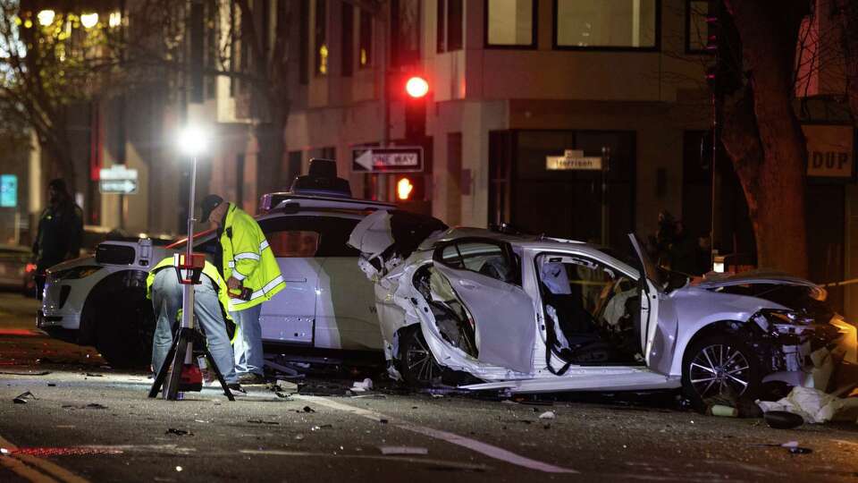 Cars including a Waymo rest at the scene of a crash at Sixth and Harrison Streets in San Francisco on Sunday, Jan. 19, 2025.