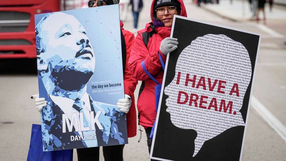 Ka’ hea Johnson, left, and Lesly Rangel march down the street carrying signs honoring the Rev. Dr. Martin Luther King, Jr., as they participating in the 47th Annual “Original” MLK Jr. Day Parade on Monday, Jan. 20, 2025 in Houston.